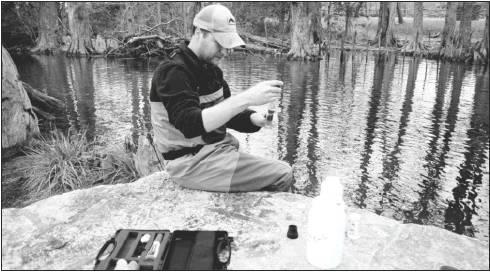 A Texas Stream Team volunteer at work testing water quality.             